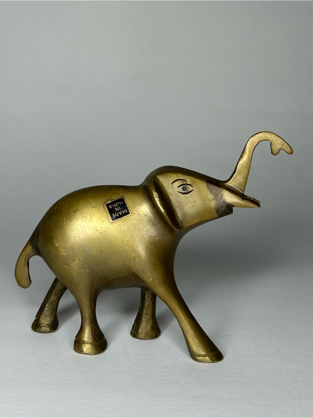 Vintage brass small happy elephant trunk up